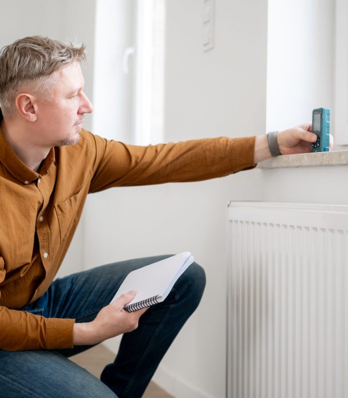 Man Measuring Window Height